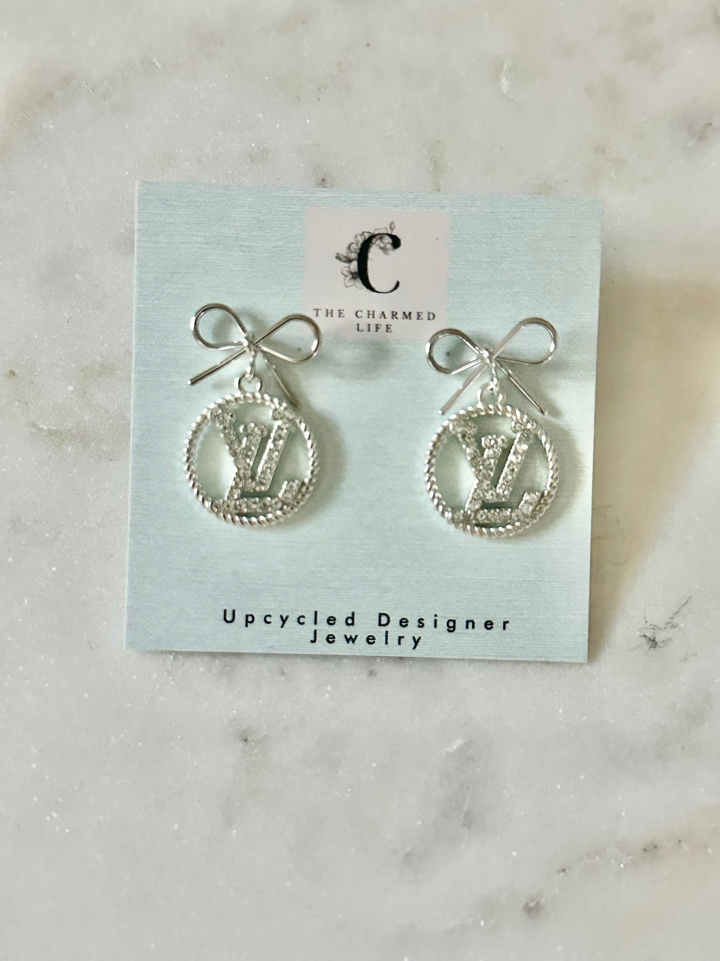 LV circle rhinestone bow earrings