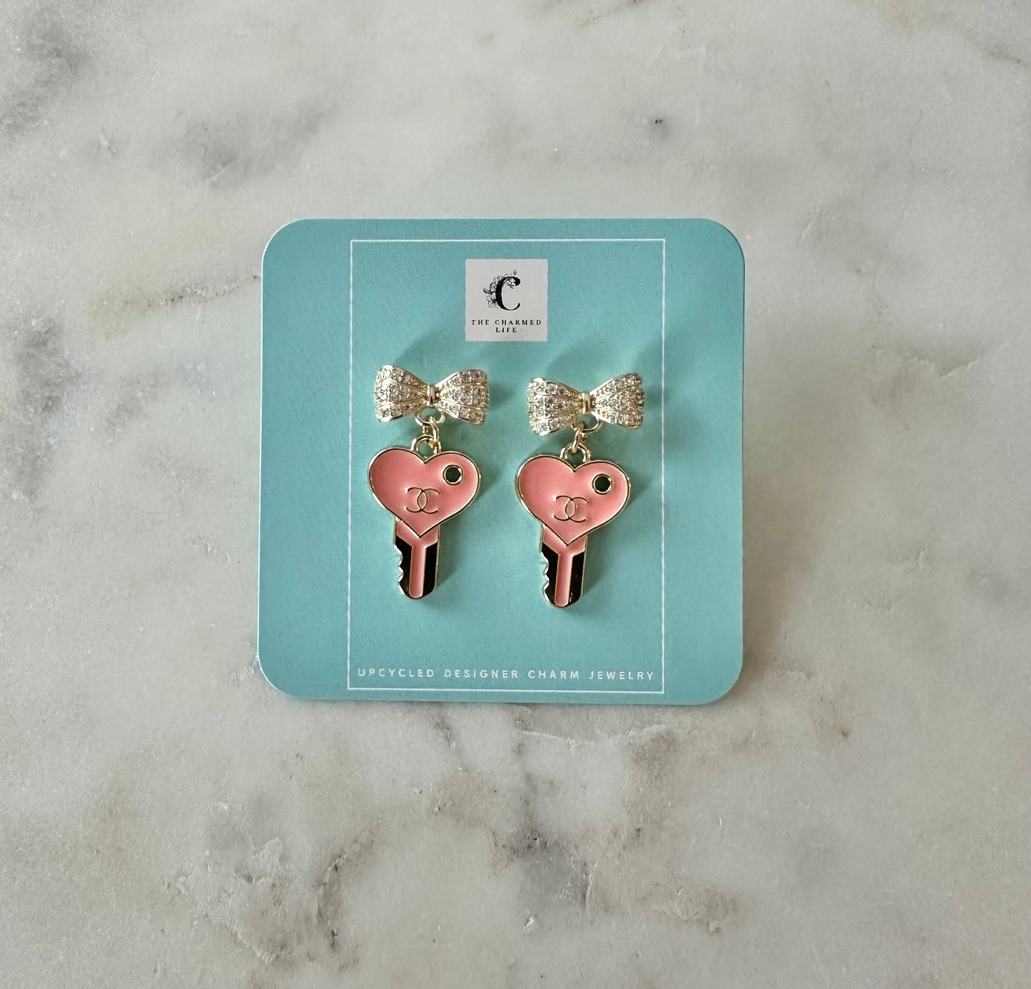 CC pink key bow earrings