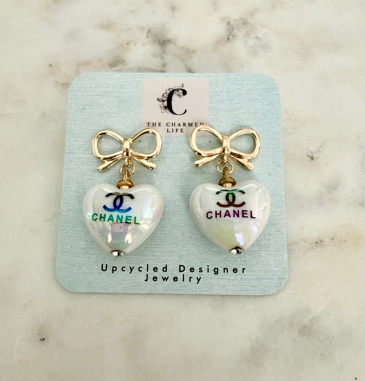 CC iridescent heart and bow earrings