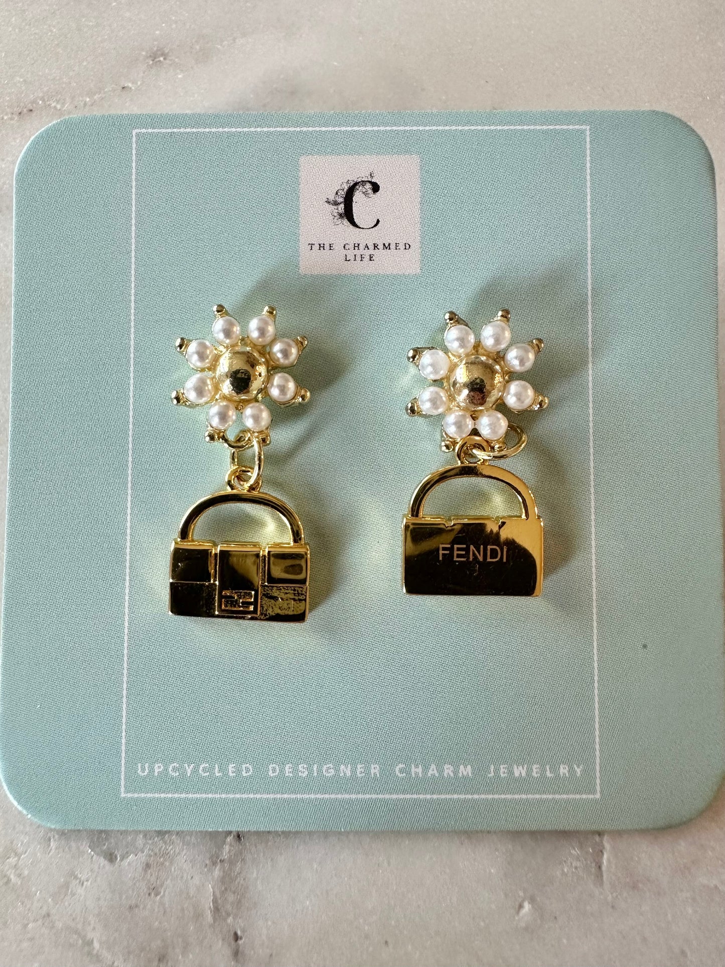 Fendi bag with faux pearl earrings