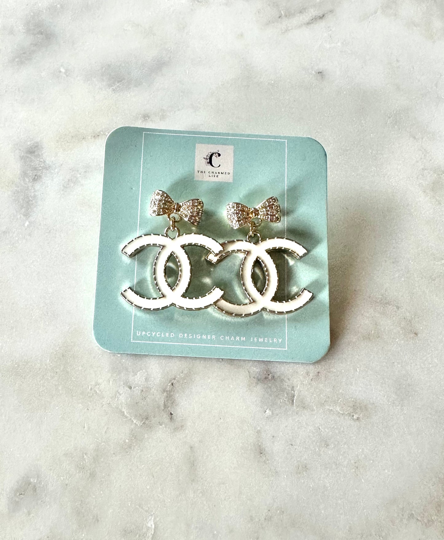 CC white and bow pendant earrings