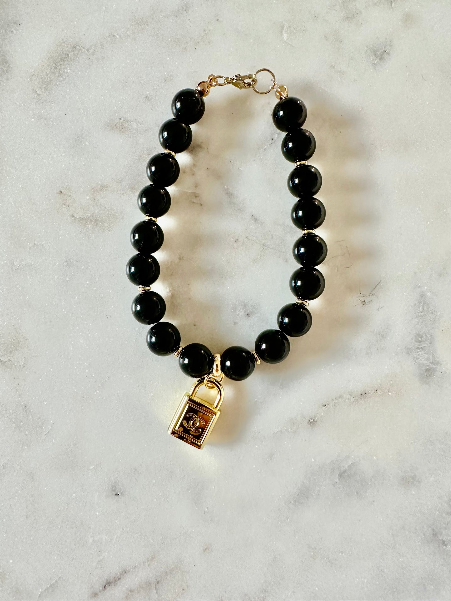CC gold lock and black quartz bracelet