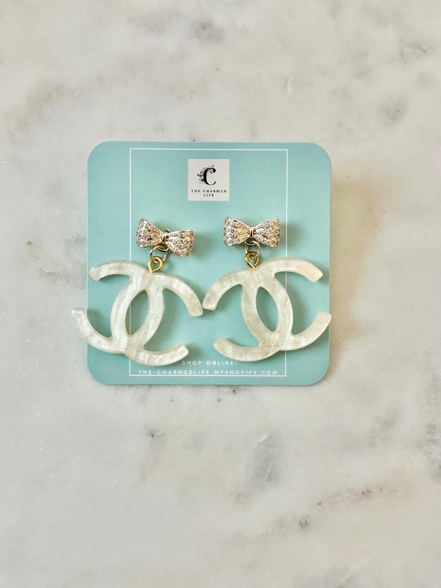 CC cream resin bow earrings