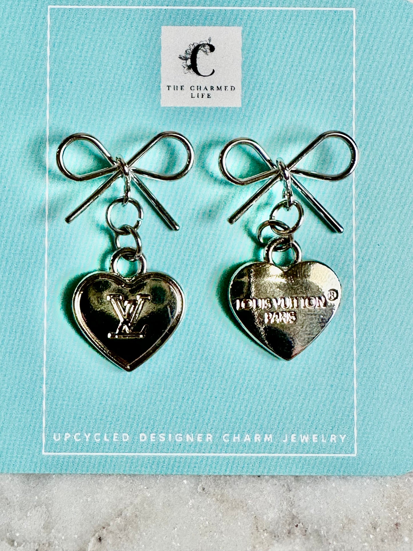 LV heart and bow silver tone earrings