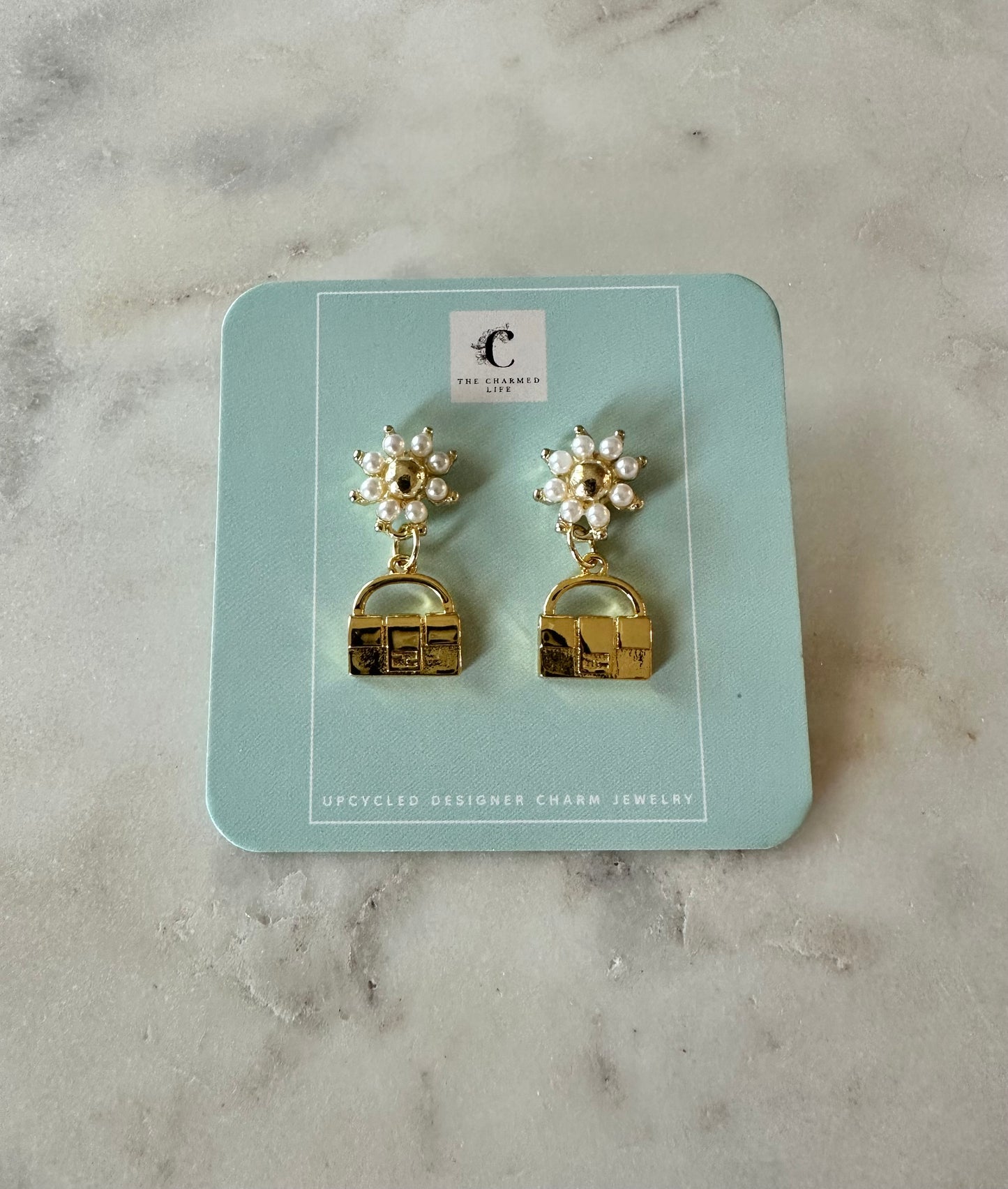 Fendi bag with faux pearl earrings