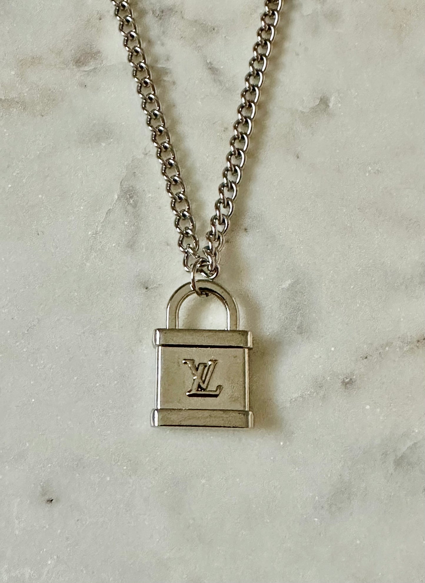 LV lock silver tone necklace
