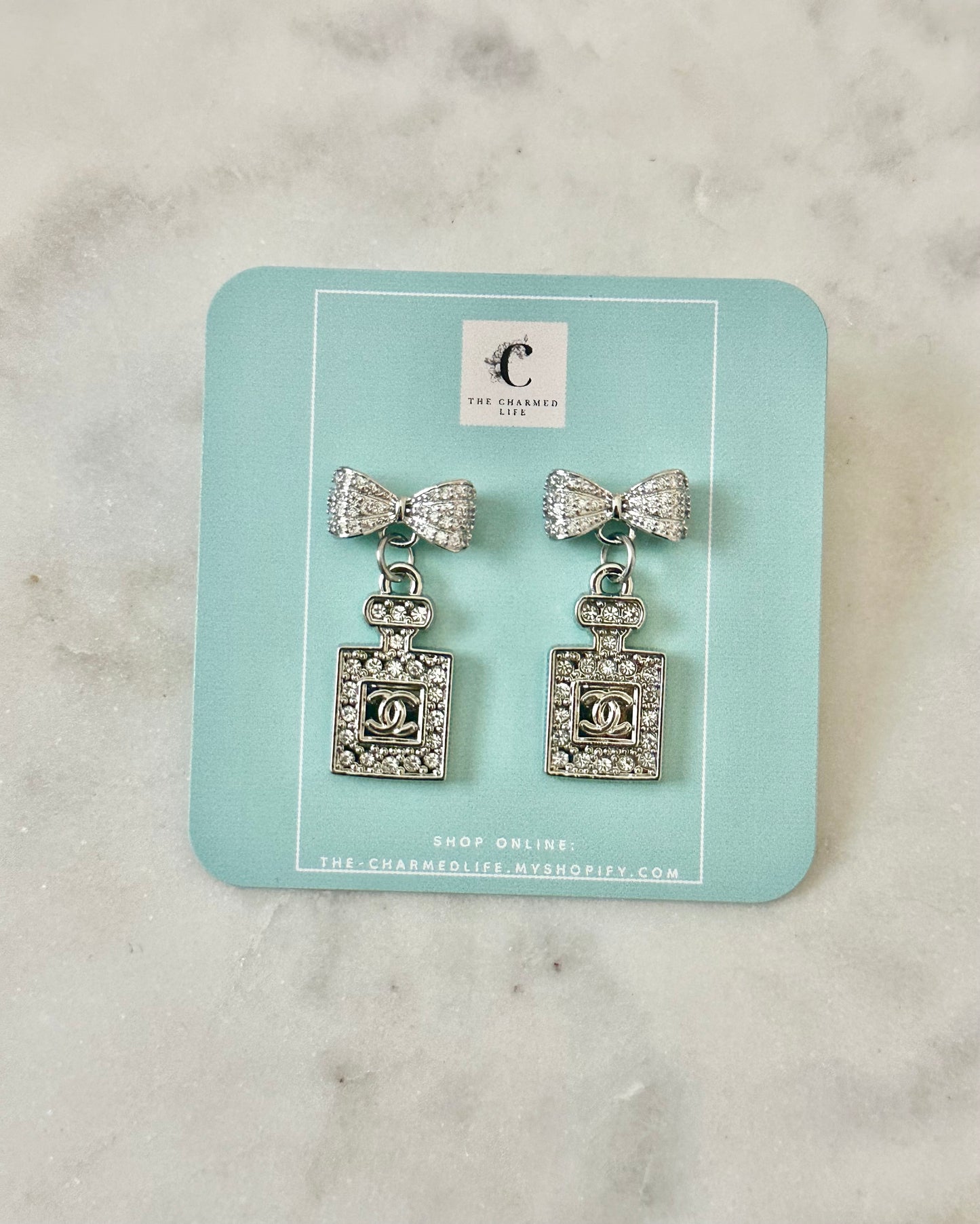 CC rhinestone perfume bow earrings silver tone
