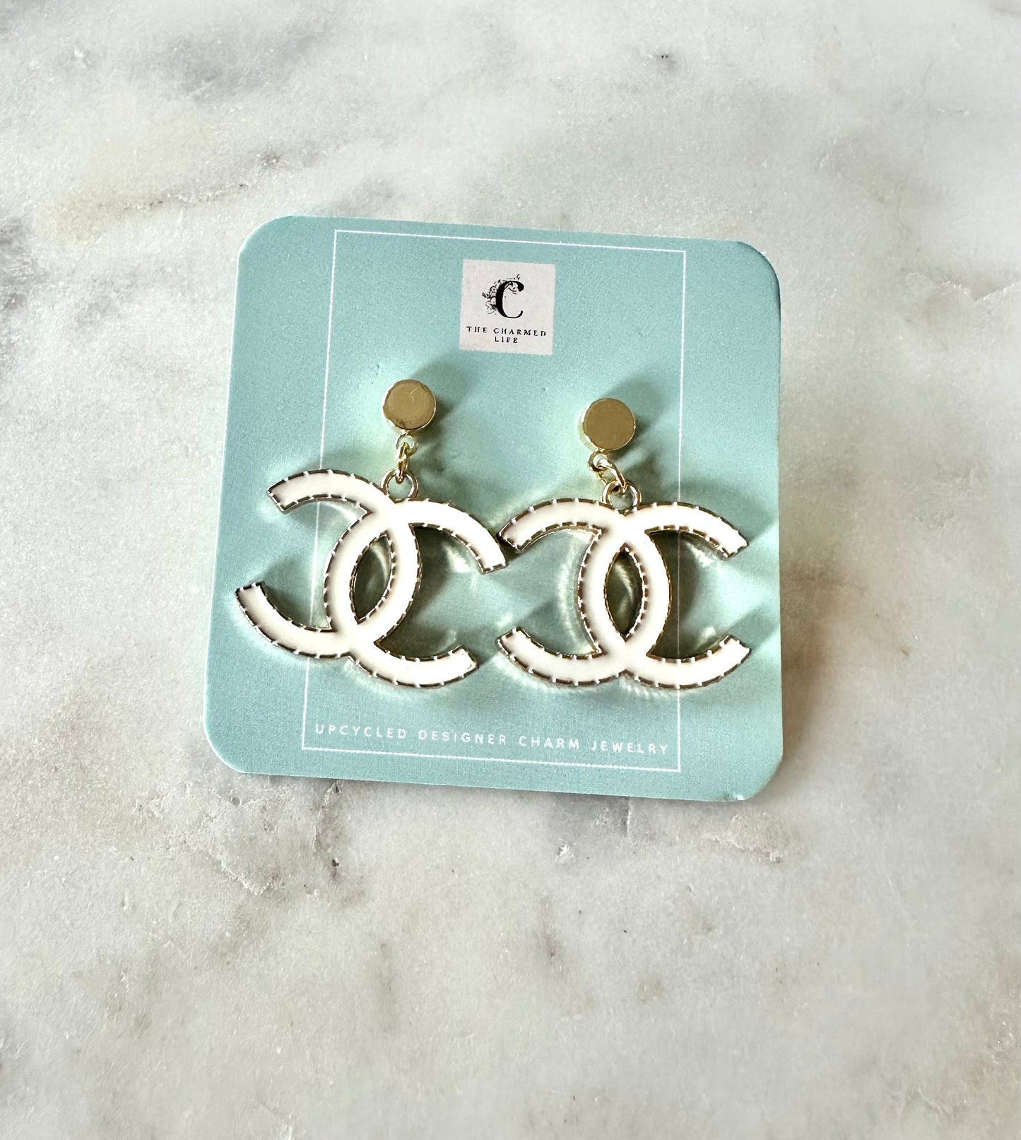 CC white pendant earrings
