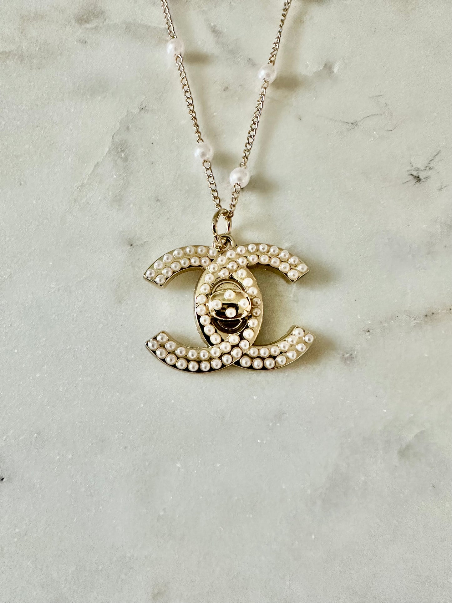 CC faux pearl turnlock necklace