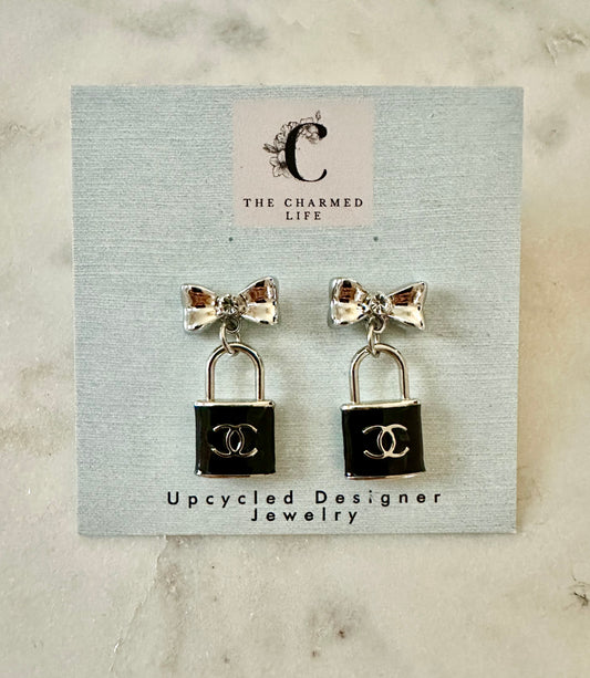 CC lock and bow silver tone earrings
