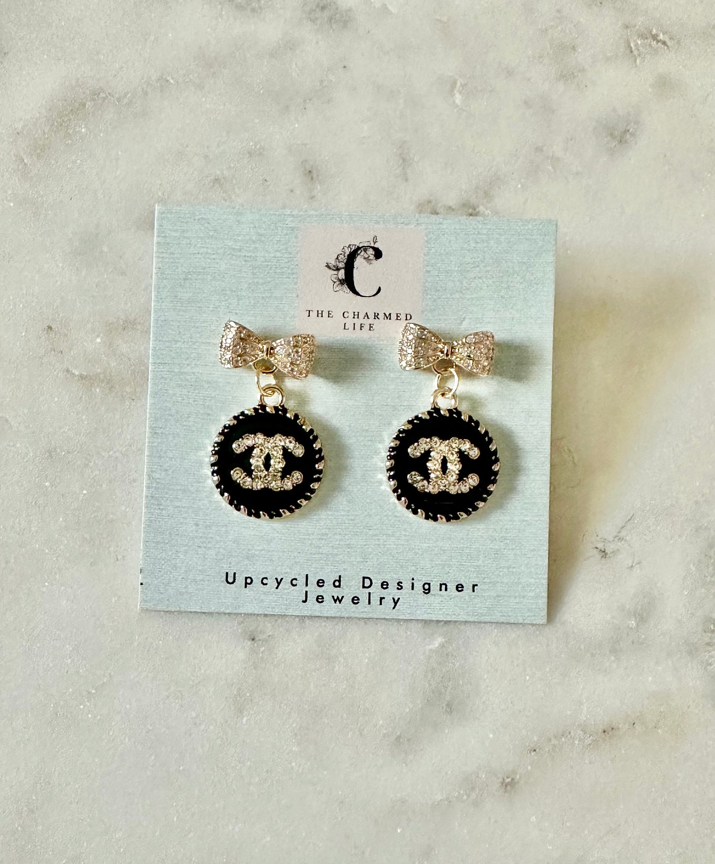 CC black bow round earrings