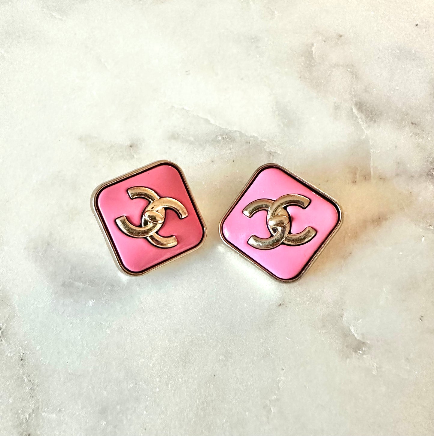 CC pink turn lock button earrings