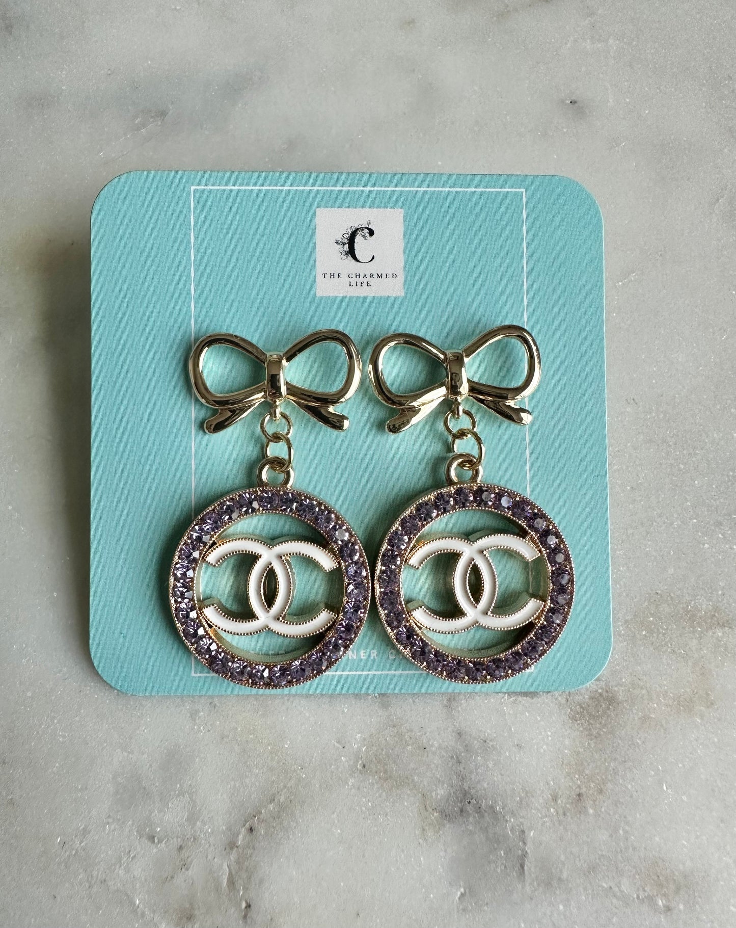 CC purple and bow earrings