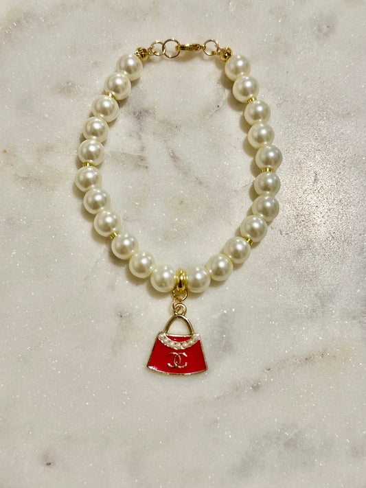CC pink purse faux pearl bracelet