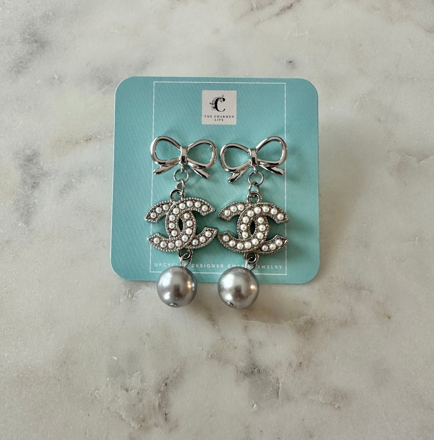 CC pearl silver tone bow earrings with gray faux pearls