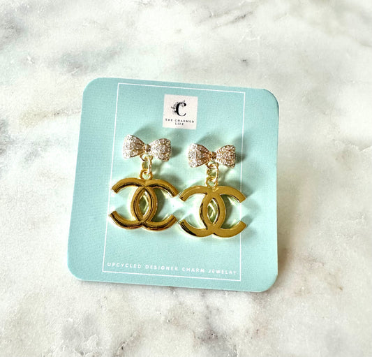CC gold and bow pendant earrings