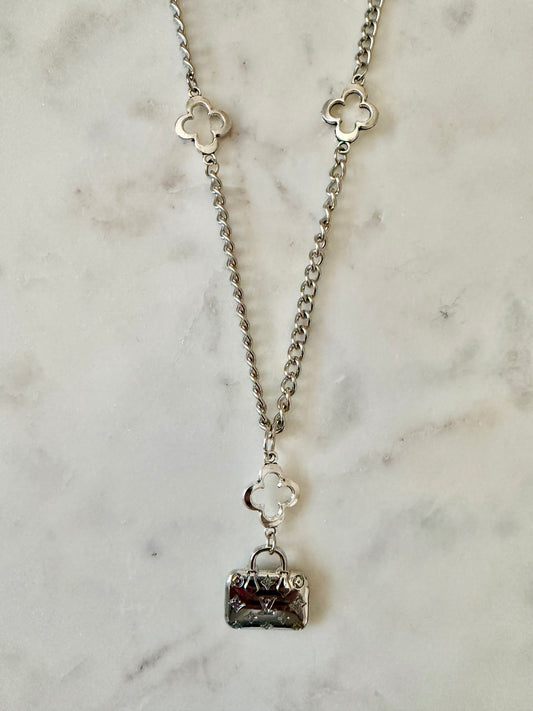 LV bag and clover necklace