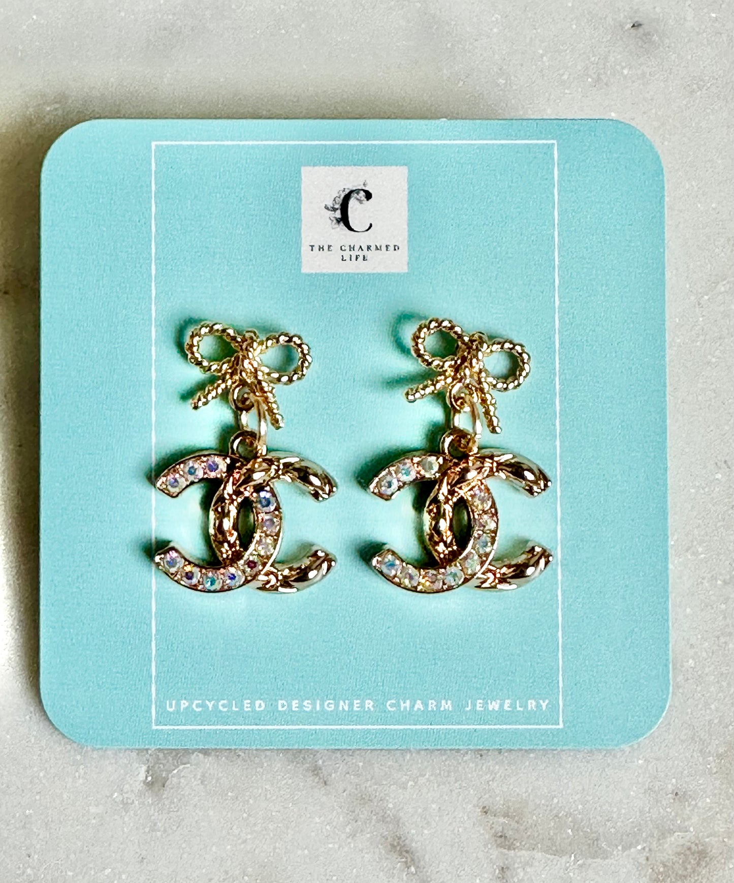 CC iridescent bow earrings
