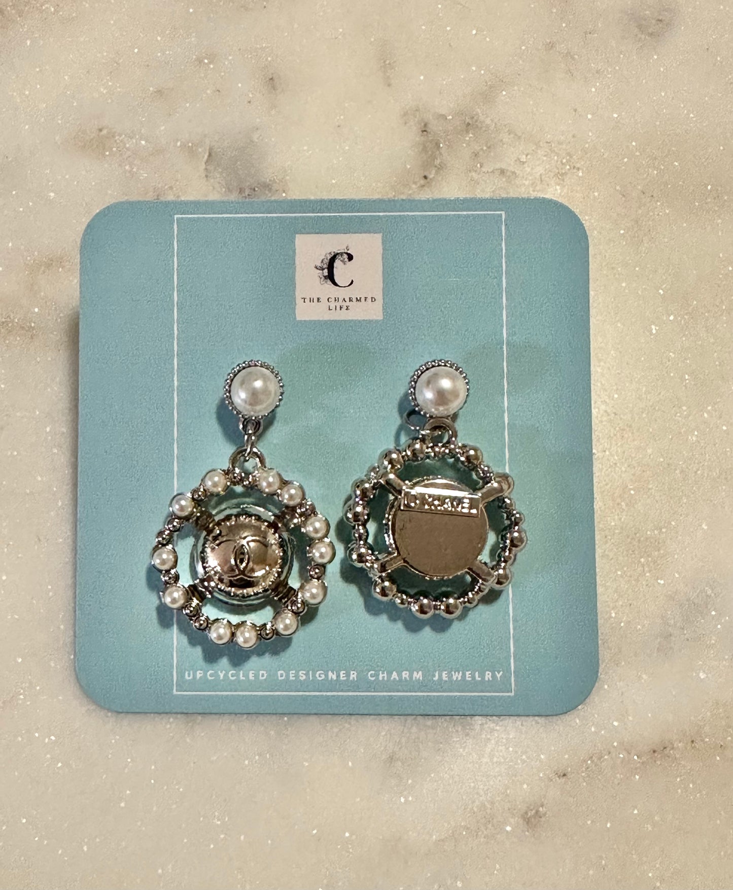 CC pearl and silver tone earrings